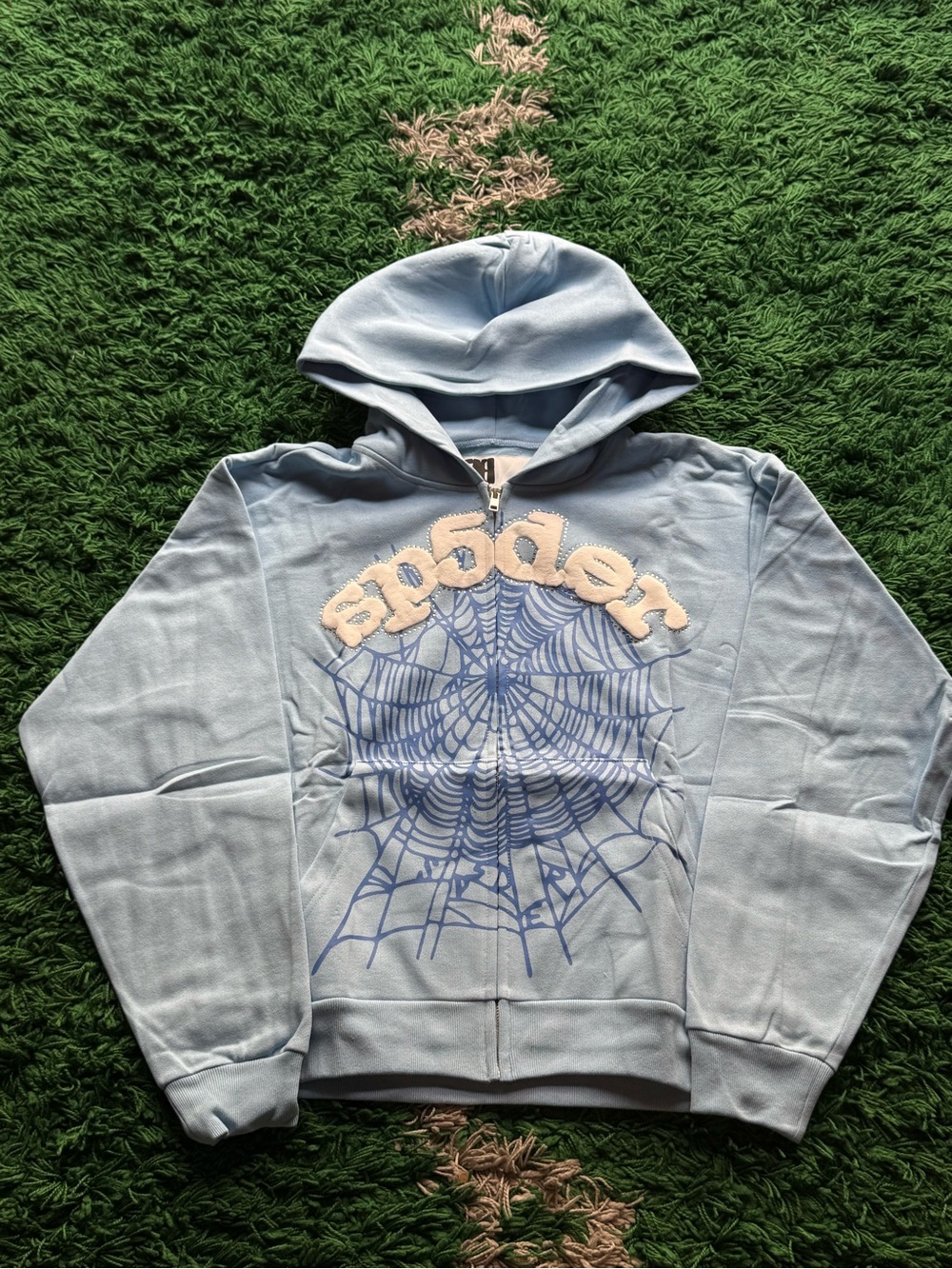 Light Blue Zip-Up Hoodie with Spider Web Graphic